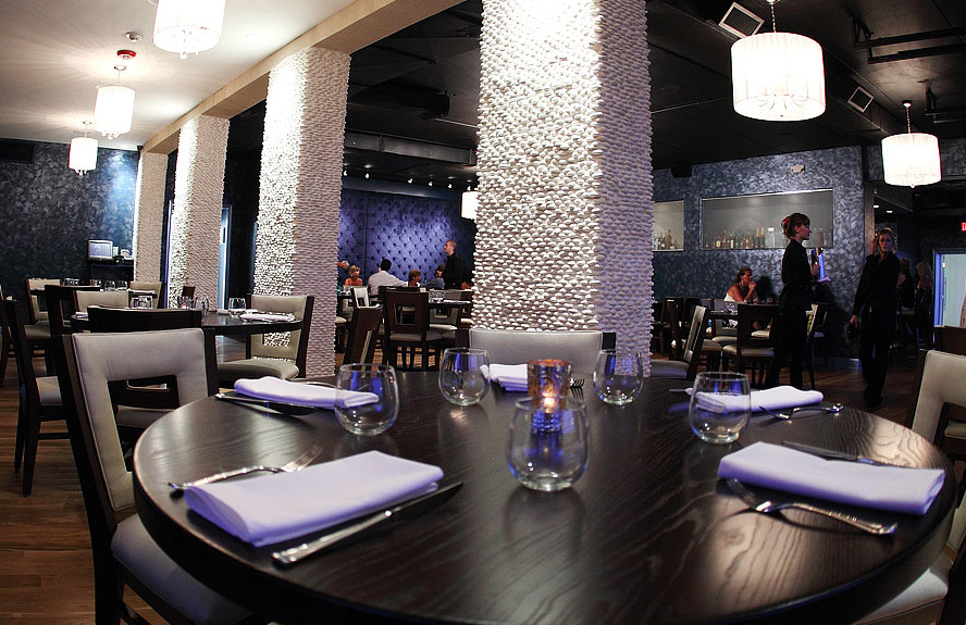 Photo of pebble pillars at SeaSalt Restaurant interior and tables