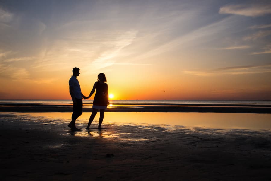 Romantic couple on beach at sunset