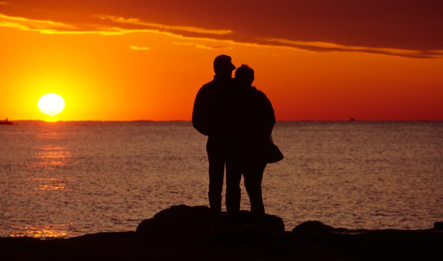 Silhouette of two people at sunset