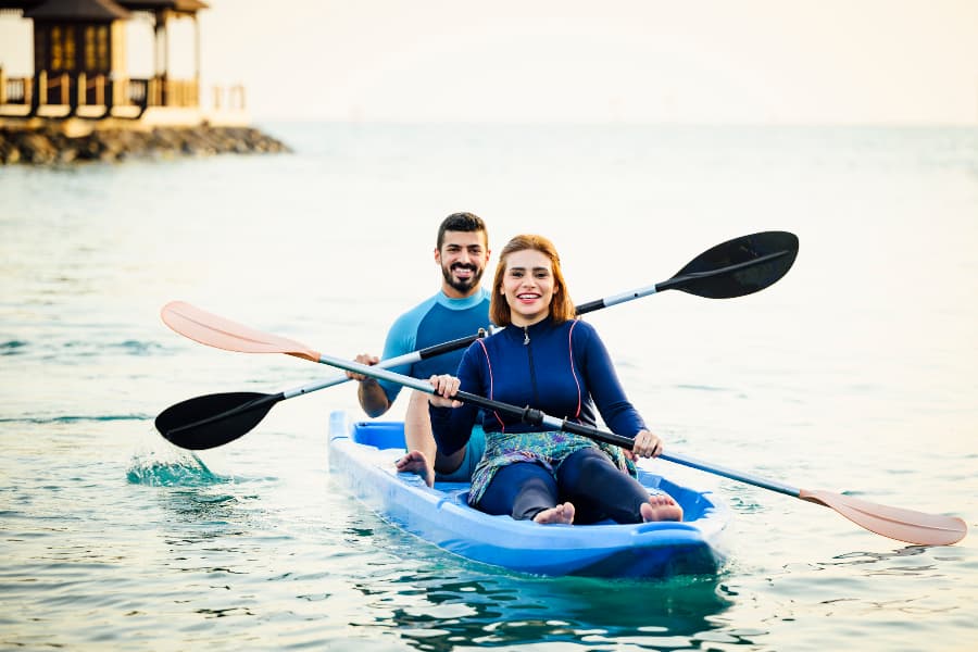 Couple smiling at camera while in kayak