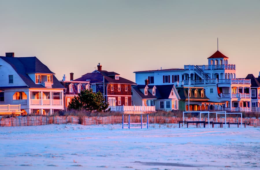 Cape may beach and houses with snow on ground